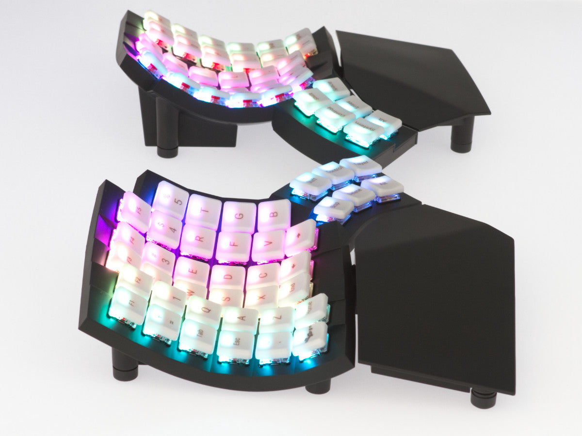 MoErgo Glove80 contoured split keyboard with low-profile choc switches and integrated thumb clusters in white plastic